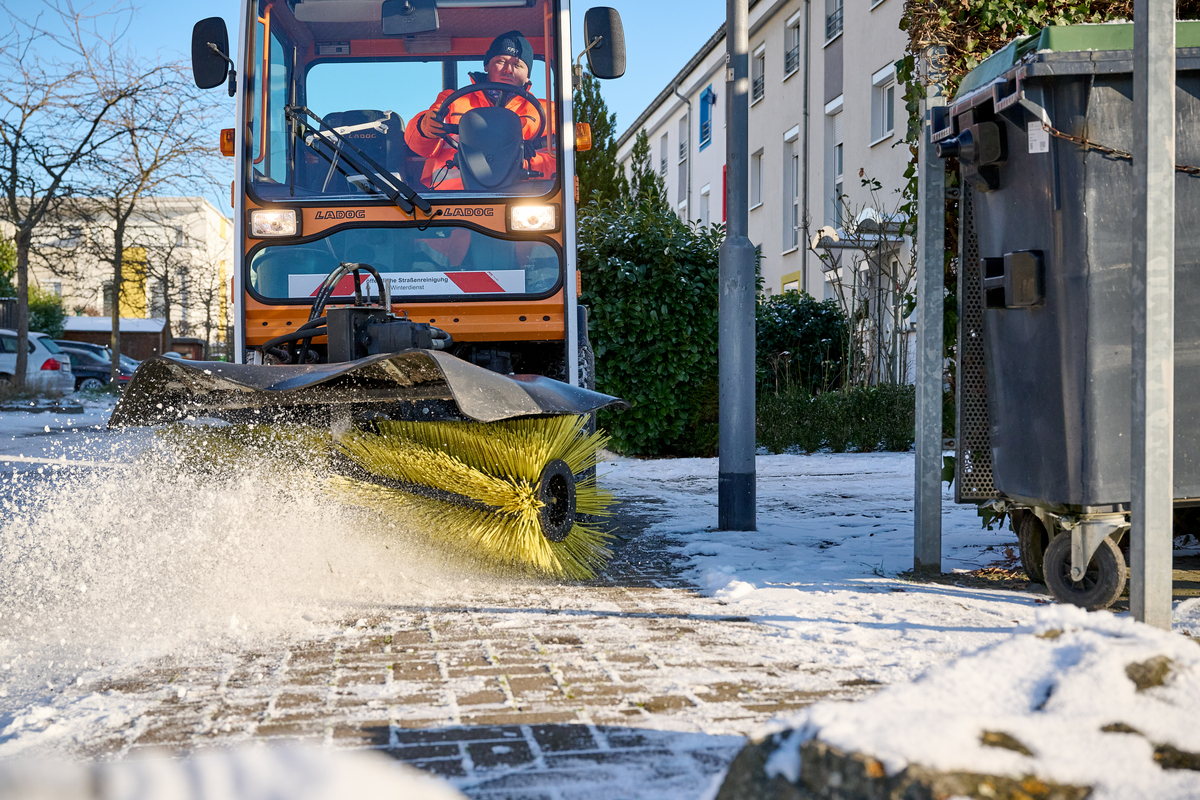 Gehwegräumfahrzeug räumt Schnee von einem Gehweg